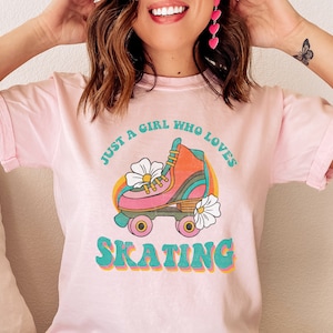 May include: Pink t-shirt with a retro roller skate graphic and the text "Just a girl who loves skating".