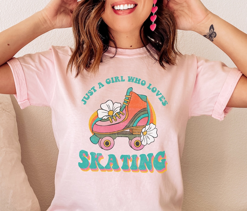May include: Pink t-shirt with a retro roller skate graphic and the text "Just a girl who loves skating".