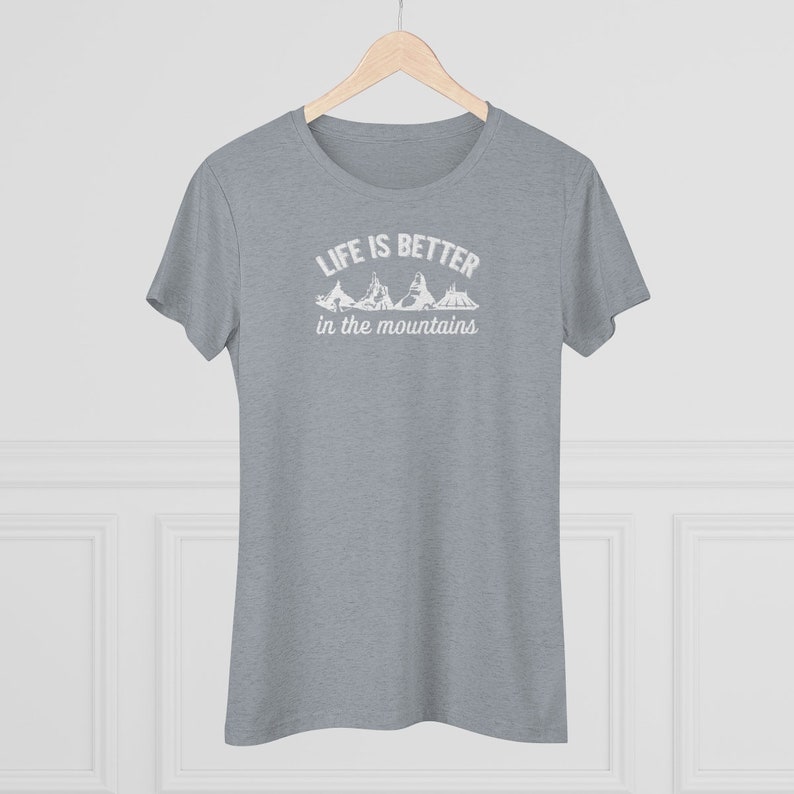 May include: A heather grey t-shirt with a white graphic that reads "Life is better in the mountains" with a silhouette of mountains.