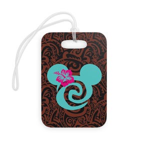 May include: A brown luggage tag with a blue Mickey Mouse silhouette with a pink hibiscus flower. The background is a brown and black tribal pattern.