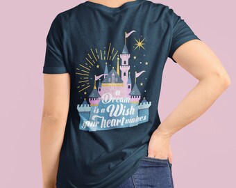 May include: A navy blue t-shirt with a pink and blue castle graphic and the text "A Dream is a Wish Your Heart Makes".
