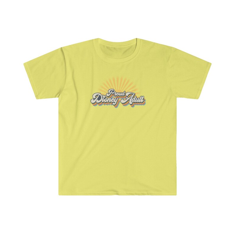 May include: A yellow t-shirt with a retro-style graphic that says "Proud Disney Adult" with a rainbow-colored sunburst behind the text.