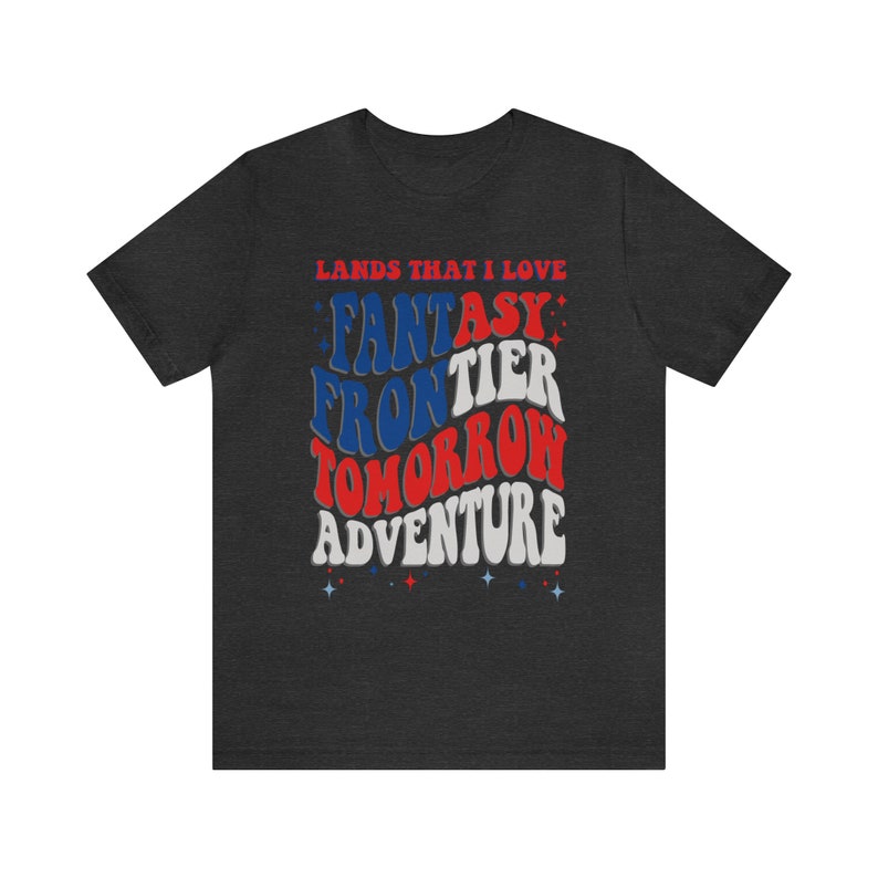 May include: Dark grey t-shirt with a red, white, and blue graphic design that says "Lands That I Love" and "Fantasy Frontier Tomorrow Adventure".