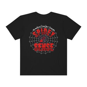 May include: Black t-shirt with a red spider web design and the text "Always Trust Your Spidey Sense".