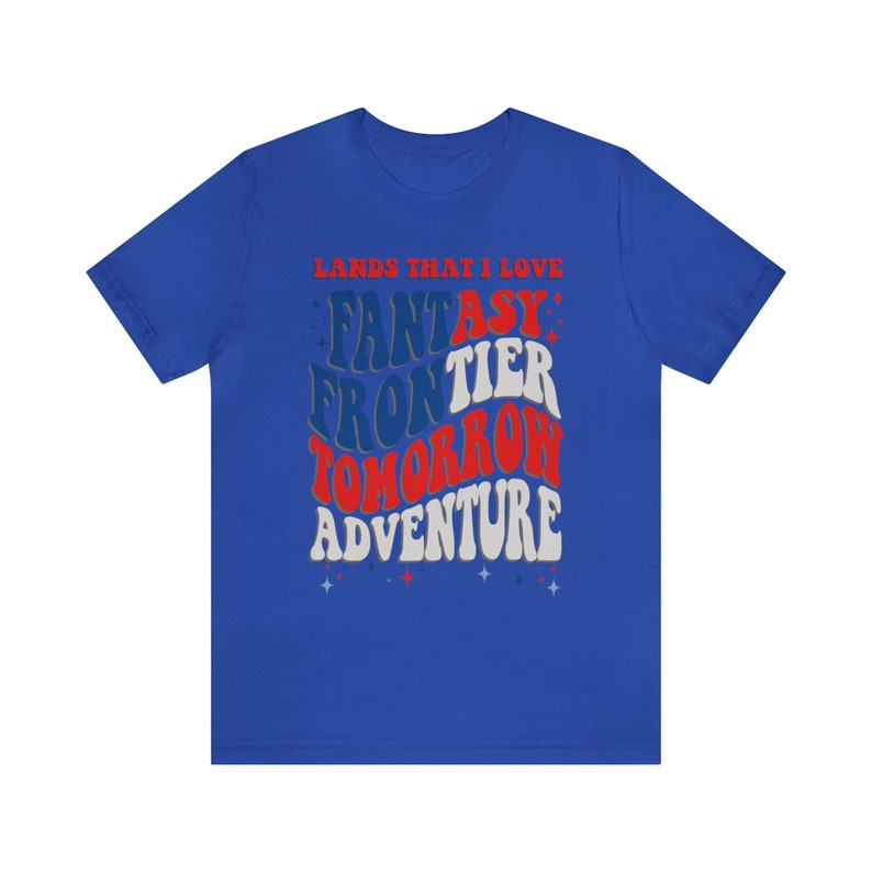 May include: A royal blue t-shirt with a white, red, and blue graphic design that says "Lands That I Love" and "Fantasy Frontier Tomorrow Adventure".