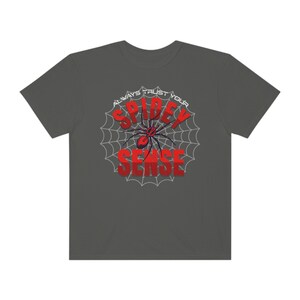 May include: A dark gray t-shirt with a white spider web design and the text "Always Trust Your Spidey Sense" in red and blue letters.