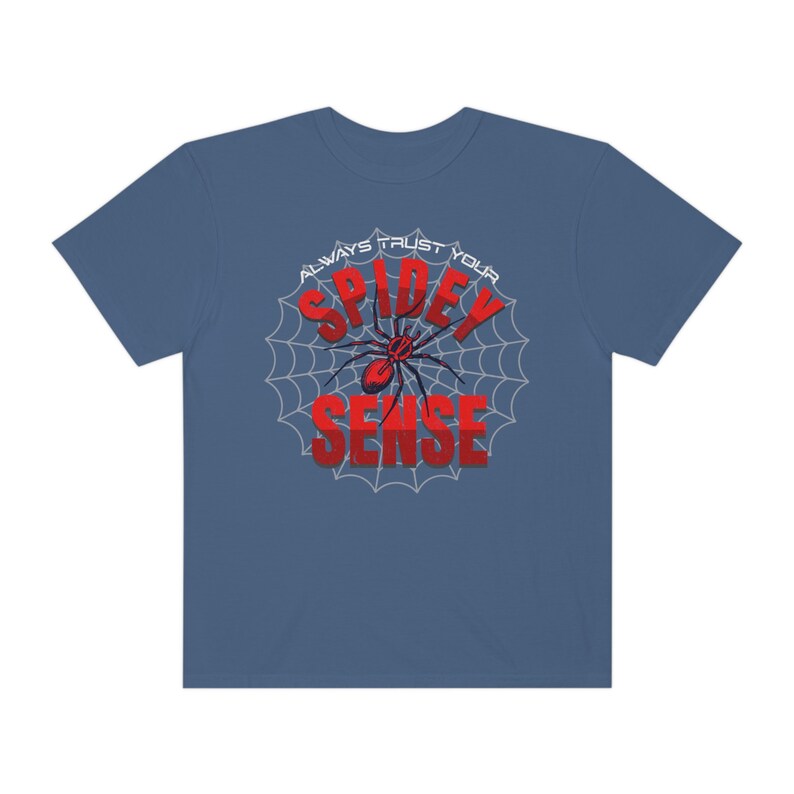 May include: A blue t-shirt with a white spider web design and the text "Always Trust Your Spidey Sense" in red.