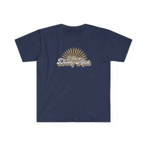 May include: A navy blue t-shirt with a retro-style graphic that says "Proud Disney Adult" with a sunburst behind the text.