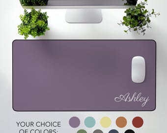 May include: A purple desk mat with a white mouse and the name "Ashley" in a white script font.