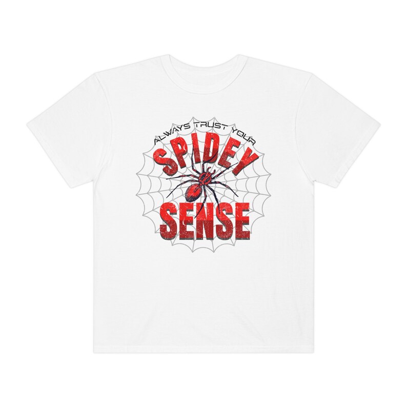 May include: White t-shirt with a red spider graphic and the text "Always Trust Your Spidey Sense" in a white spiderweb.