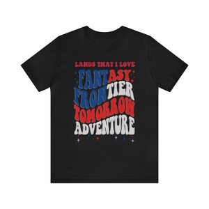 May include: Black t-shirt with a red, white, and blue graphic that says "Lands That I Love" and "Fantasy Frontier Tomorrow Adventure".