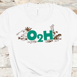 May include: White t-shirt with a brown graphic of animals and plants surrounding the text "O2H" in teal.