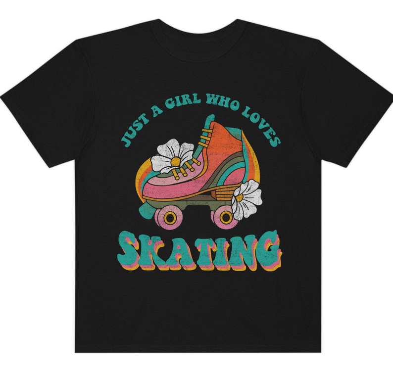 May include: Black t-shirt with a retro graphic of a roller skate with flowers and the text "Just a girl who loves skating".