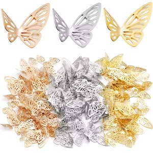 Könnte beinhalten: Eine Auswahl an Metall-Schmetterlingsverzierungen in Gold, Silber und Roségold. Die Schmetterlinge weisen filigrane Ausschnitte in den Flügeln auf und sind in verschiedenen Größen erhältlich. Ideal für Bastelarbeiten, Schmuckherstellung oder Dekorationsprojekte.