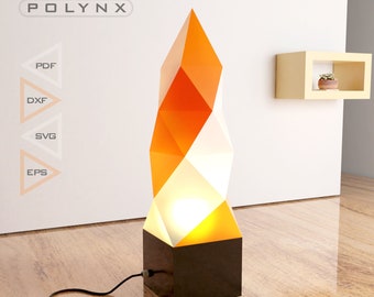 May include: A modern, geometric floor lamp with a white and orange design. The lamp has a black base and a cord.
