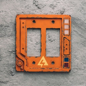 May include: Orange metal electrical outlet cover with two blank switch plates, a lightning bolt warning symbol, and a series of small buttons.