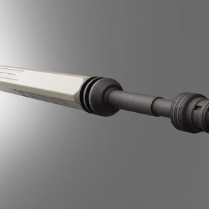 May include: A white and black futuristic-looking tool with a long, cylindrical body and a rounded tip. The tool has a series of grooves and ridges along its length.