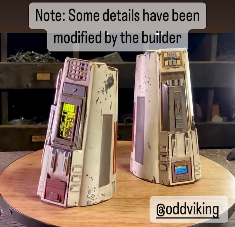 May include: Two white, weathered, detailed, sci-fi prop models with various buttons, lights, and panels. The models are on a wooden surface. Note: Some details have been modified by the builder. @oddviking