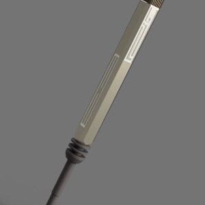 May include: A silver and gray metal tool with a textured handle and a long, thin shaft. The tool has a series of grooves and ridges along the shaft.