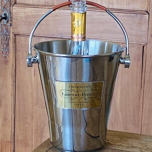 Laurent Perrier Champagne cooler/ Champagne bucket in polished stainless  steel and featuring leather covered handle and gold front plaque