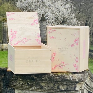 Wooden champagne crates. Pair of Deutz champagne wooden crates in raw natural wood with beautiful blossom design. Faubulous wooden lids