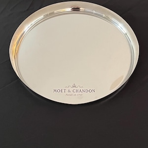 Moet Chandon round bistro champagne tray. In metal with front engraving. In the cravate design