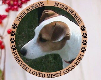 May include: A round wooden Christmas ornament with a photo of a dog and the text "Your Always In Our Hearts Forever Loved Missy 2005-2021".