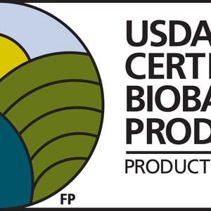 May include: A white rectangular graphic with the text "USDA CERTIFIED BIOBASED PRODUCT PRODUCT 100%". The graphic includes a circular design with a yellow sun, green hills, and blue water.