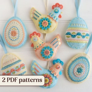 May include: Six felt ornaments, including two chickens and four eggs, with embroidered details in shades of blue, yellow, and pink. The ornaments are hanging from white ribbon and are displayed against a white wooden background. The text "2 PDF patterns" is visible at the bottom of the image.