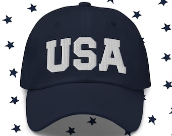 May include: A navy blue baseball cap with a white embroidered "USA" on the front.