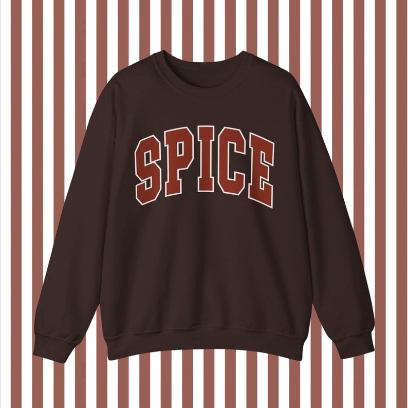 May include: A brown sweatshirt with the word "SPICE" printed in red on the front.
