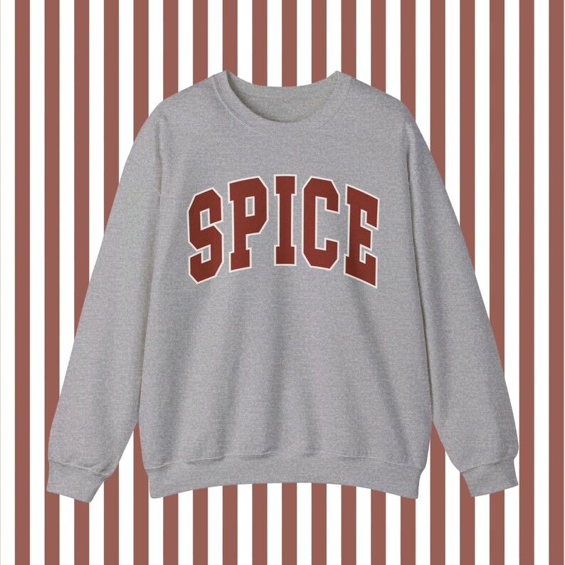 May include: A gray sweatshirt with the word "SPICE" printed in large, red letters across the front.