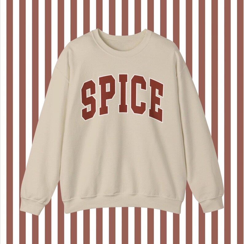 May include: A beige sweatshirt with a red "SPICE" graphic printed on the front.