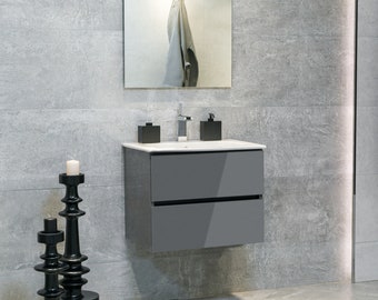 May include: A gray bathroom vanity with two drawers, a white sink, and a chrome faucet. There are two black soap dispensers and a mirror above the sink. Two black candle holders are on the floor.