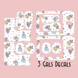 May include: A collection of princess-themed decals in various shapes and sizes, featuring illustrations of princesses and mermaids in yellow, blue, and purple. The decals are set against a white background with a pink backdrop, and the text "3 GALS DECALS" is displayed.