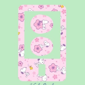 May include: Pink phone case with a white outline and a repeating pattern of cartoon dogs and pink flowers. The text "3 Gals Decals" is at the bottom of the case.