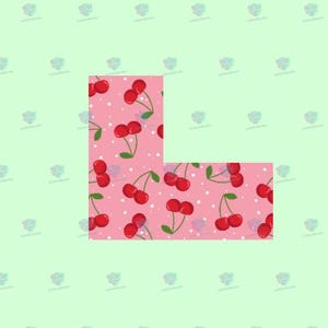 May include: A pink background with a white polka dot pattern and red cherries. The cherries are arranged in a pattern that forms the letter L.