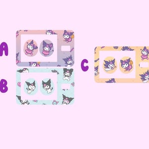 May include: Three different designs for a phone case featuring a cartoon character with black fur, purple eyes, and a pink bow. The character is wearing a witch costume and holding a pumpkin. The phone cases are in pink, blue, and yellow.