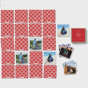 May include: A custom photo memory game set featuring square cards with a red and white checkered heart pattern on the back. Some cards display personal photographs of couples in outdoor settings. Includes a red box labeled Photo Memory Game.
