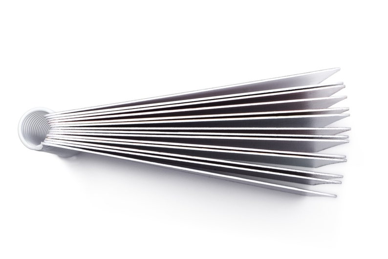 May include: A stack of white business cards fanned out in a circular shape. The cards are held together by a metal ring.