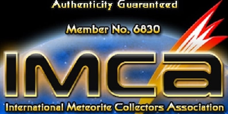 May include: A black and blue graphic logo for the International Meteorite Collectors Association, featuring the bold text IMCA, the phrase Authenticity Guaranteed, and Member No. 6830, accompanied by a stylized orange and white lightning bolt icon.