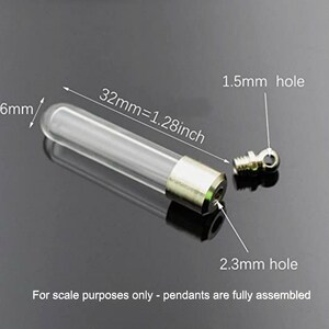 May include: A clear glass vial pendant with a metallic cap, measuring 32mm or 1.28 inches in length and 6mm in diameter. The cap features a 2.3mm opening and a separate screw-in eyelet with a 1.5mm hole for attachment to jewelry chains or cords.