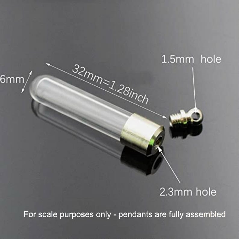 May include: A clear glass vial pendant with a metallic cap, measuring 32mm or 1.28 inches in length and 6mm in diameter. The cap features a 2.3mm opening and a separate screw-in eyelet with a 1.5mm hole for attachment to jewelry chains or cords.