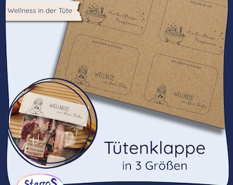 May include: A product image featuring a kraft paper sheet with four printed labels, each with a unique design. The labels have the text "Wellness in der Tüte" and "Anti-Stress Programm". A small bag with the same text is also visible. The image also includes the text "Tütenklappe in 3 Größen".