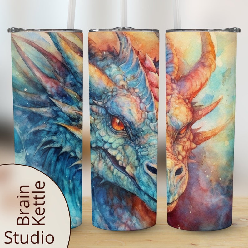May include: Three stainless steel tumblers featuring a watercolour dragon design. The dragon is blue, green and orange with a white background. The tumblers are a great way to keep your drinks cold or hot.