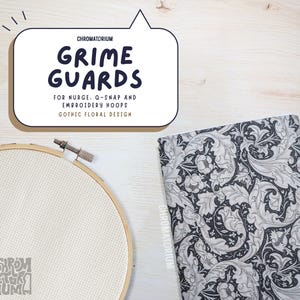 May include: An embroidery hoop with white fabric, a fabric with a black and white floral pattern, and text that reads "GRIME GUARDS" and "GOTHIC FLORAL DESIGN". The image is on a light wood surface.