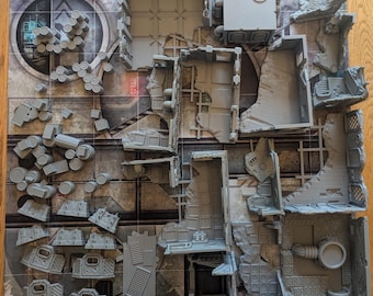 May include: A set of grey plastic building pieces for a tabletop game. The pieces are designed to look like a ruined city, with walls, floors, and other details. The pieces are arranged on a grey and white gridded surface.