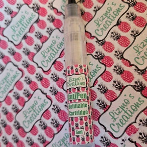 May include: A clear plastic refillable cartridge for a CutiPen, labeled "Lizmo's Creations CutiPen Refillable Cartridge 6ml". The cartridge is on a white background with a pattern of pink pineapples.