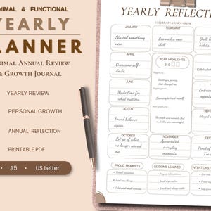 May include: A yearly planner and growth journal with a beige background featuring the text Minimal & Functional Yearly Planner. A black pen rests on a white printable PDF page titled Yearly Reflection with monthly sections and prompts.