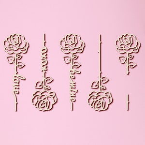 May include: Four wooden rose cutouts with the words "most", "love", "valentine", and "be" written on them. The roses are all the same design, with a simple outline of a rose with leaves and a stem.
